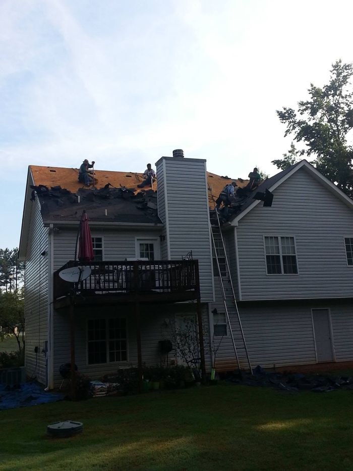 A+ crew re-roofing the back of a two-story home
